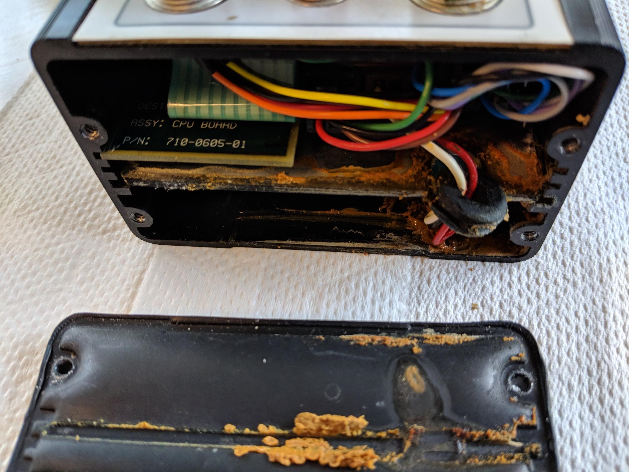 Endcap removed from FS2001F unit showing battery corrosion